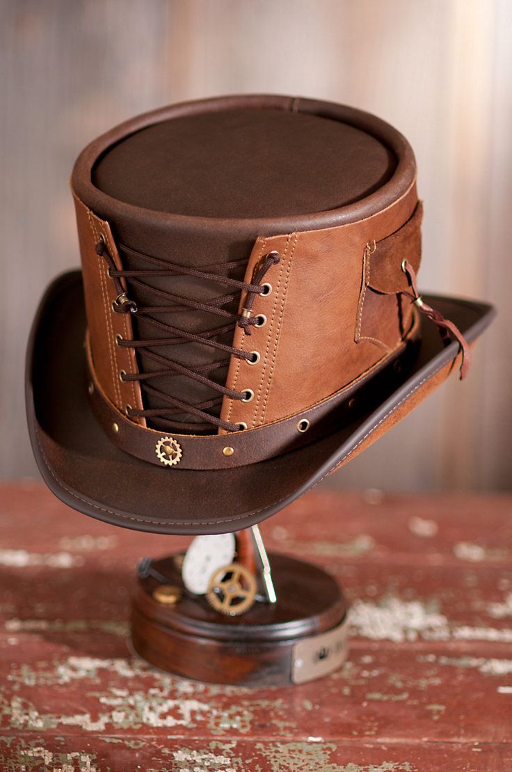 The vested steampunk hat is bedecked with lace-up corseting, bold grommets, stitching detail, and a flap pocket, for a bold fashion. Free shipping + returns. Victorian Vest, Brown Leather Hat, Moda Steampunk, Corset Steampunk, Leather Top Hat, Steampunk Top, Brown Leather Top, Steampunk Top Hat, Steampunk Hat