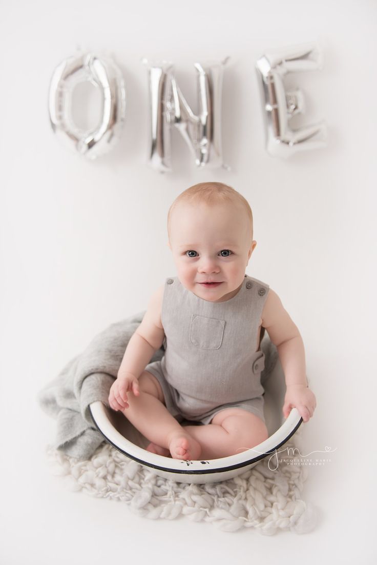 a baby sitting in a bowl with the word one on it