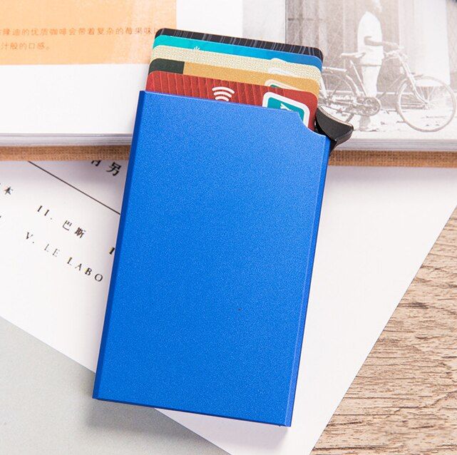 a blue notebook sitting on top of a pile of papers