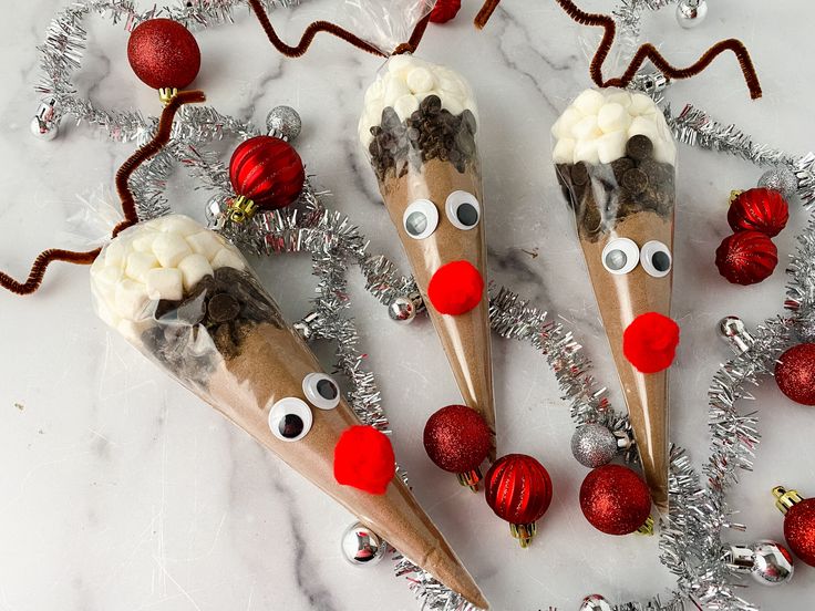 three reindeer antlers with christmas decorations and tinsel