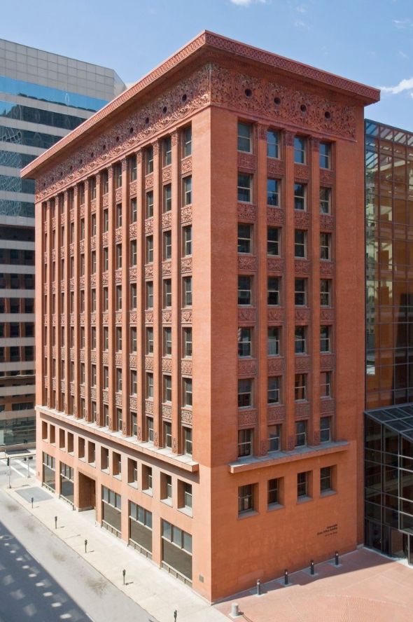 an old brick building in the middle of a city