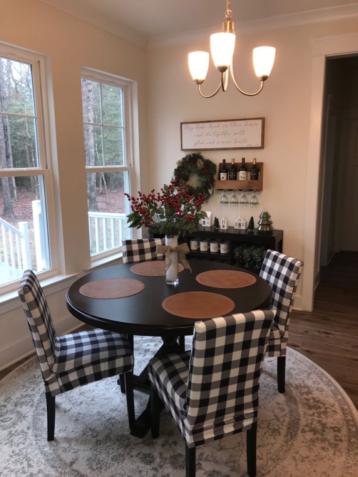 a dining room table with four chairs around it