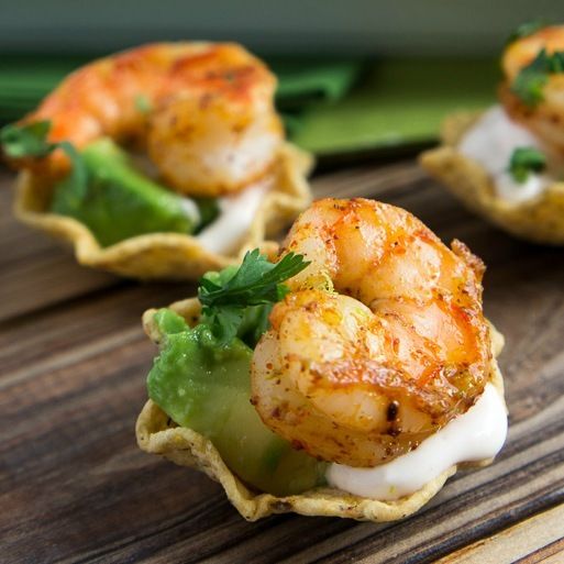 shrimp and avocado appetizers with sour cream sauce on a wooden table