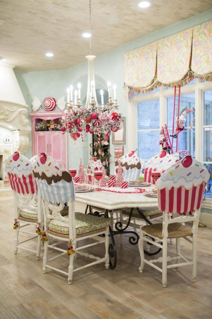 the dining room table is decorated in pink and white