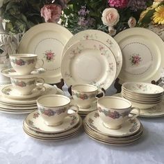 a table topped with lots of plates and cups