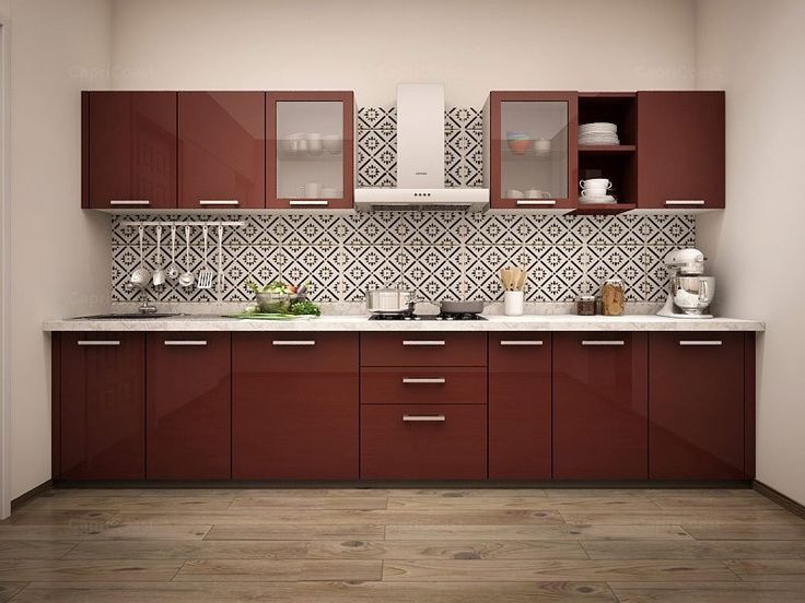 a kitchen with brown cabinets and white counter tops on the wall, along with wooden flooring