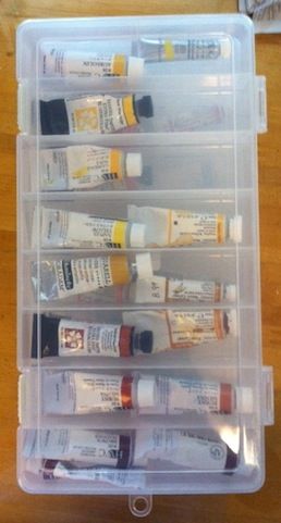 a plastic container filled with lots of different types of paint