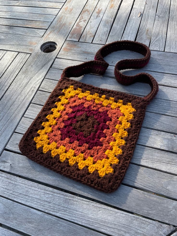 a crocheted bag sitting on top of a wooden floor