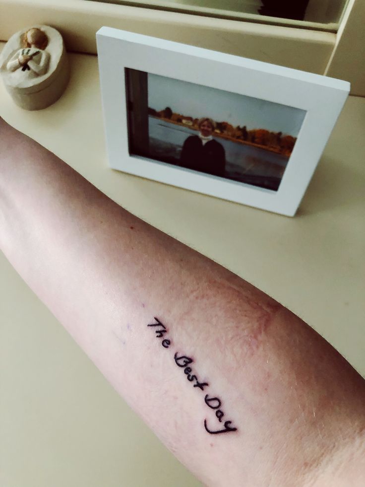 a person's arm with the word love written in cursive writing on it