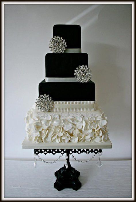 a three tiered black and white wedding cake