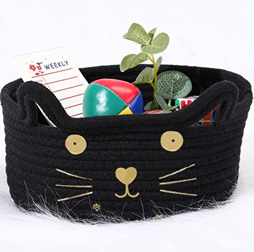 a black cat basket filled with lots of toys