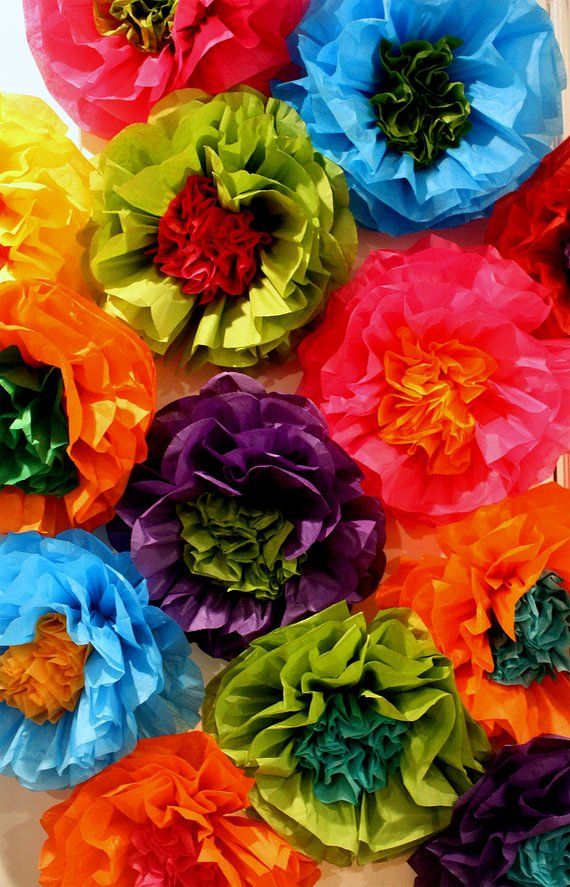 colorful paper flowers arranged on a white surface