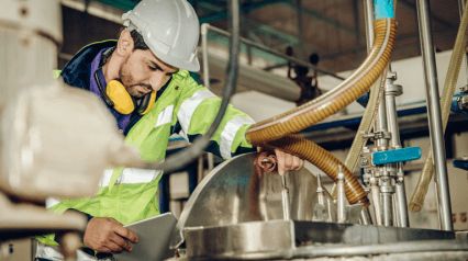 a man in safety gear working on a machine