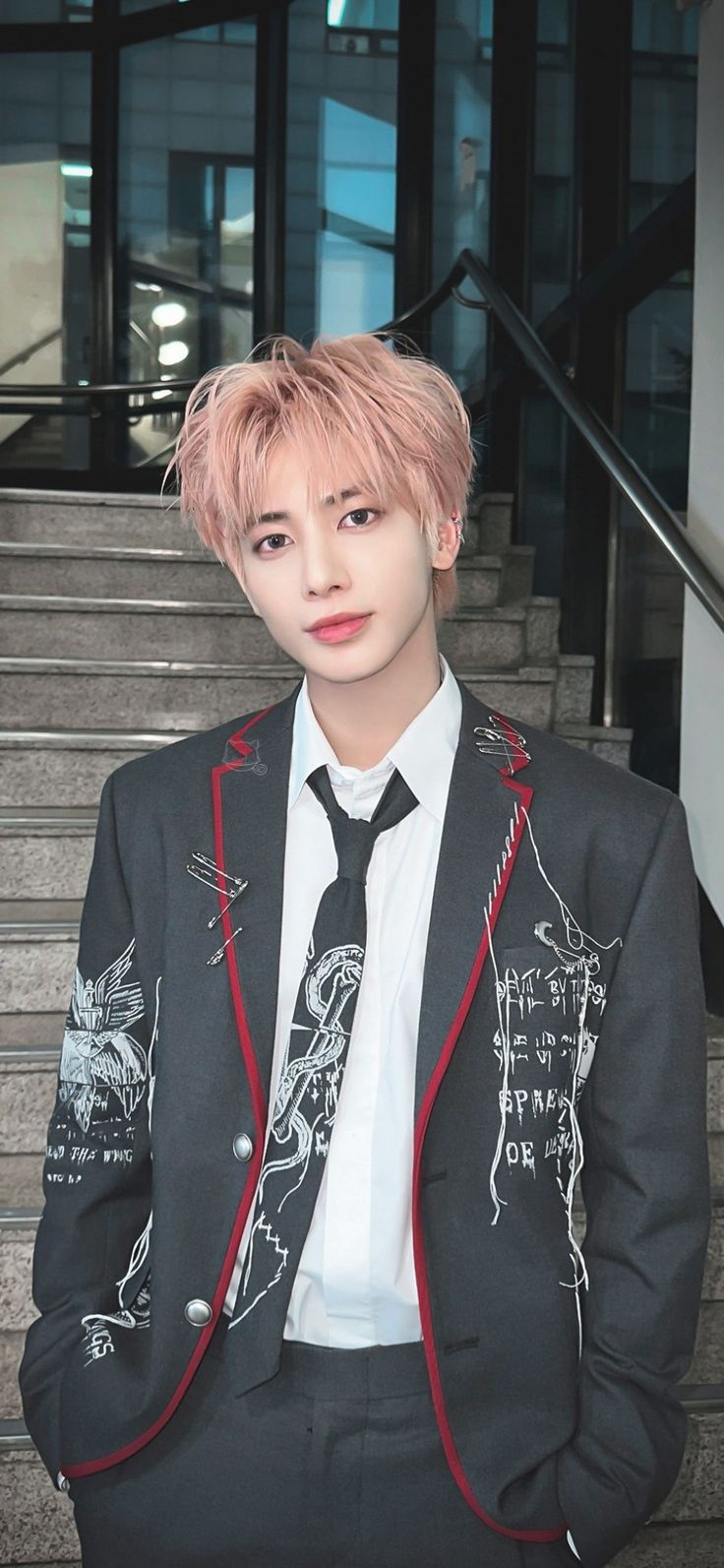 a man with pink hair wearing a suit and tie