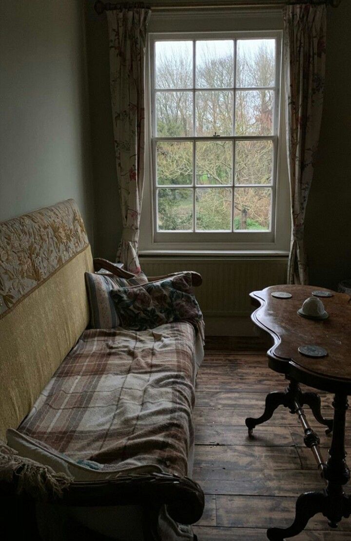 a living room with a couch, table and window