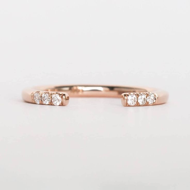 a rose gold ring with three diamonds on it