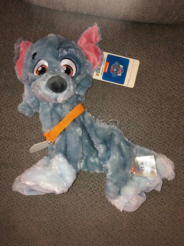 a blue stuffed animal laying on the floor next to a toothbrush and dental floss