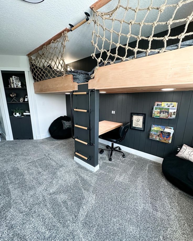 there is a loft bed with a hammock on the top and desk underneath