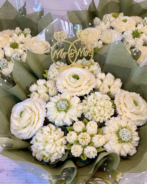 a bouquet of white flowers sitting on top of a table