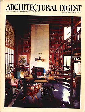 an architectural digest magazine cover shows a living room with bookshelves and furniture in it