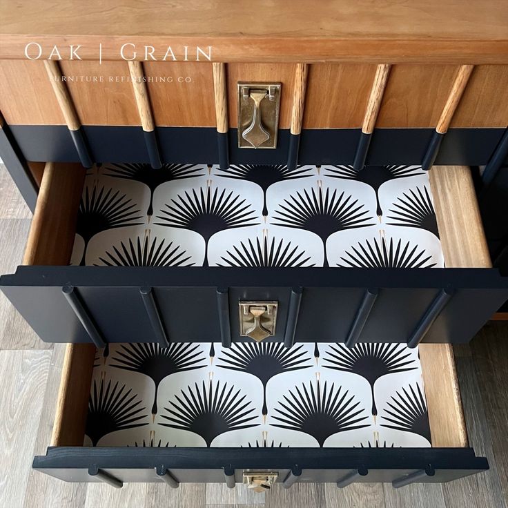 an open drawer with black and white designs on it