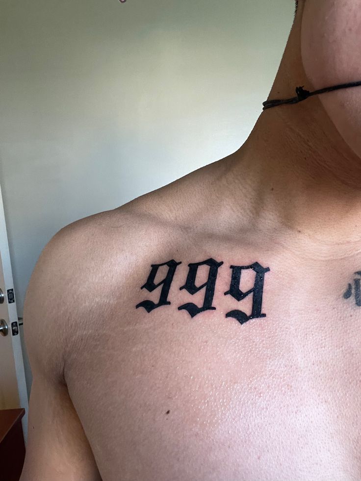 a man's chest with the word 999 tattooed on his left side shoulder