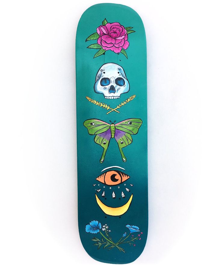 a skateboard with an image of skulls and flowers painted on it's side