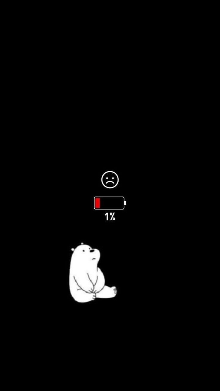 a polar bear sitting in the dark with a red light on it's head