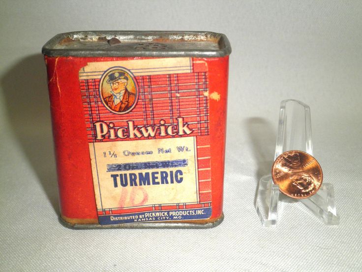 an old tin can with a penny in it next to a small glass holder for coins