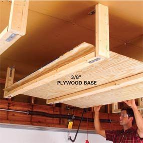 a man is working on the underside of a wooden beam in a garage with other wood planks