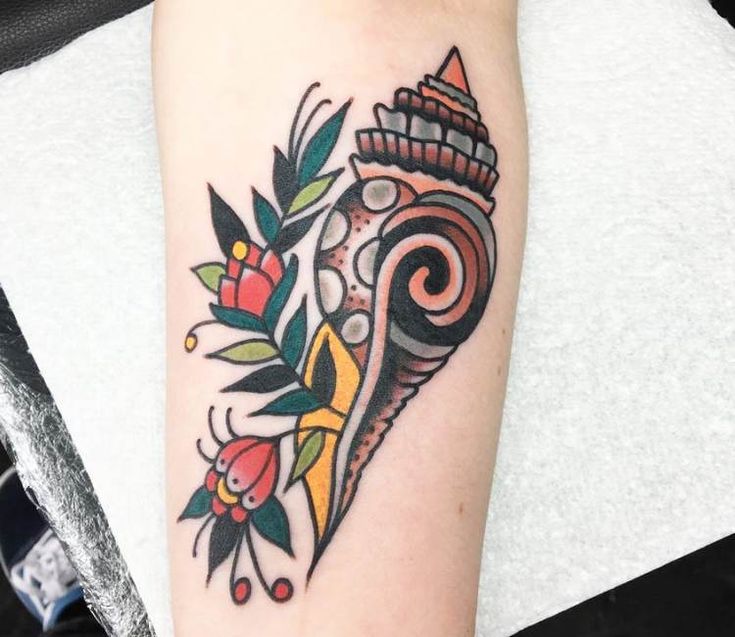 a woman's arm with a colorful tattoo design on the left side of her body