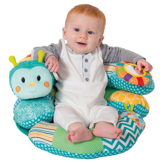 a baby sitting in a chair with stuffed animals