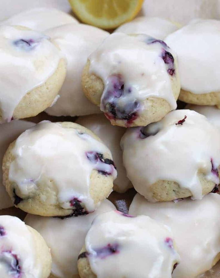 blueberry donuts with icing and a lemon slice