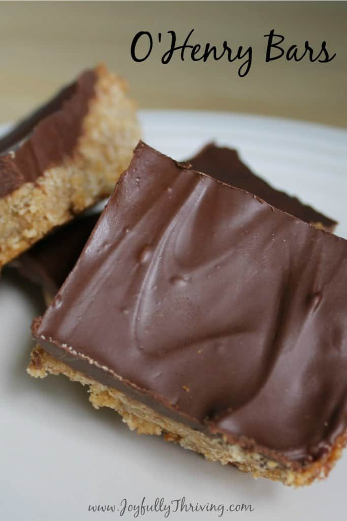 two pieces of chocolate peanut butter bar on a plate with the words, o'henry bars