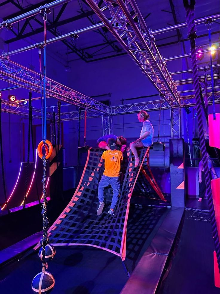 children playing on an indoor trampoline course