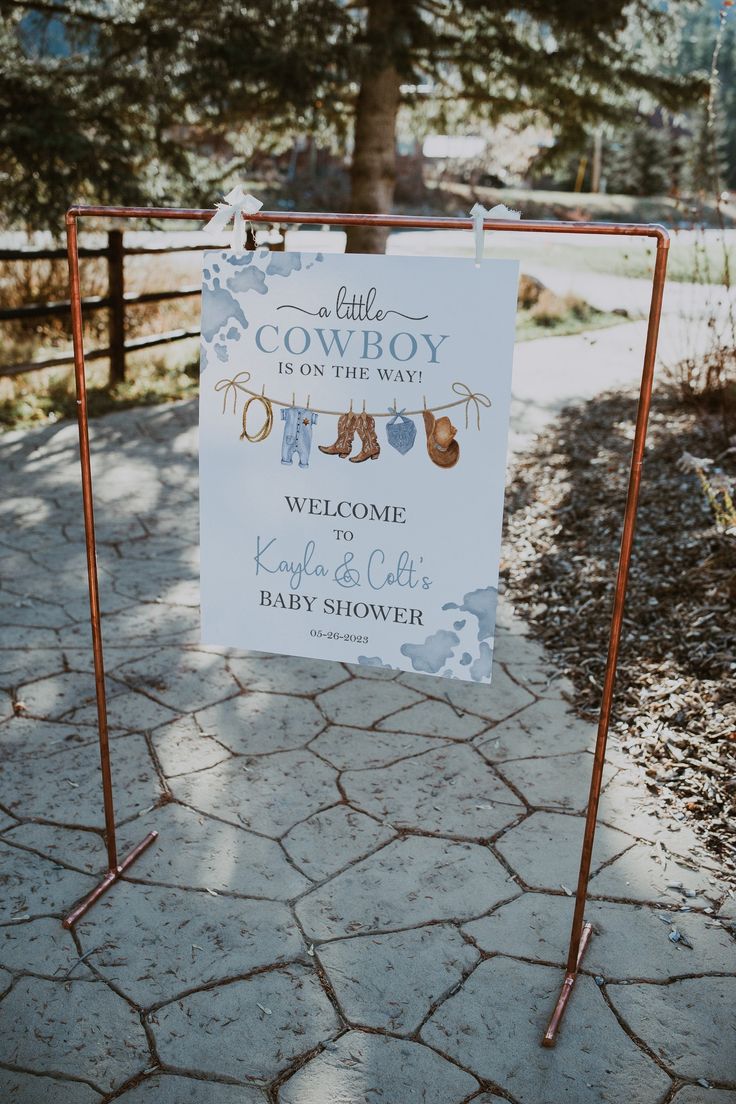 a baby shower sign on a metal stand