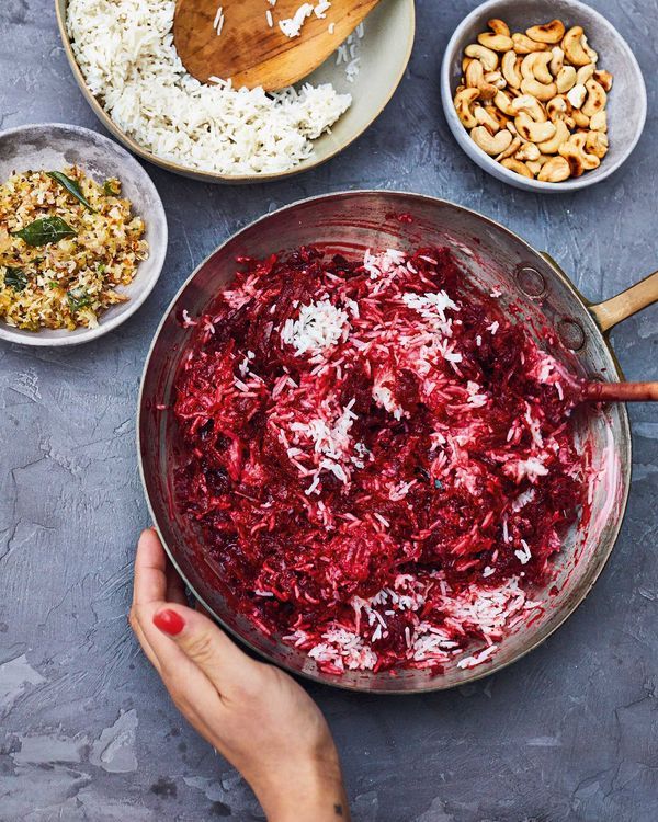 a bowl filled with red cabbage, nuts and rice