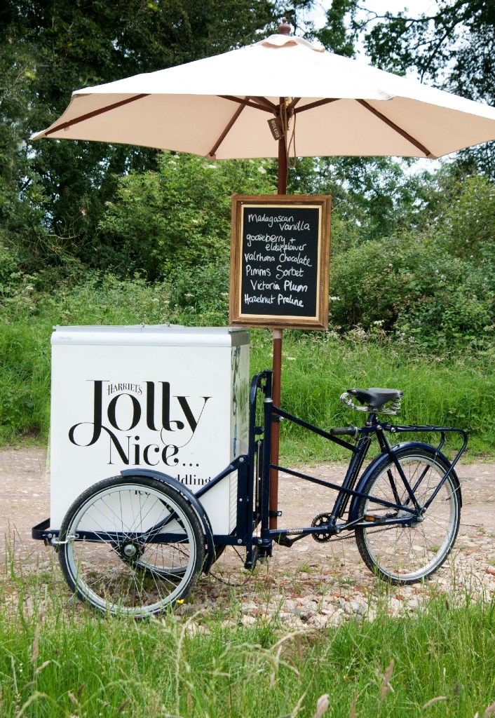 a bike parked next to a cooler under an umbrella