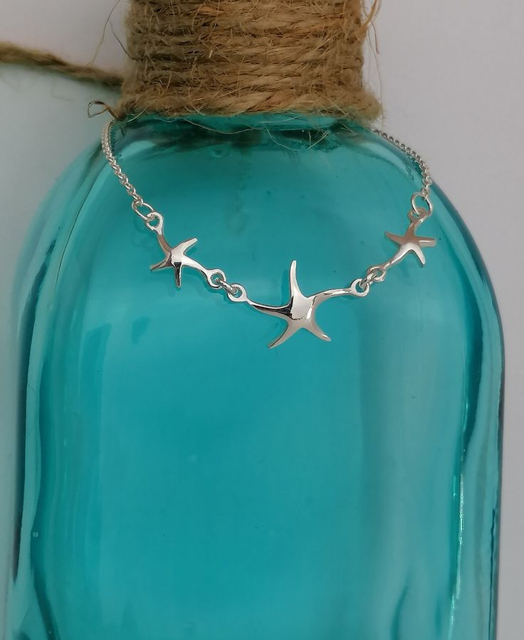 Sterling Silver Starfish Bracelet This pretty little bracelet has 3 little starfish and is a must have for beach and ocean lovers. It is 17.5cms in Length. If you are buying this as a gift for someone and want to make it extra special, how about adding one of our Messages in a Bottle...  We have 6 bottle designs to choose from and a  number of different messages and quotes that can be included on your scroll. Please follow the following link for our Messages in a bottle. https://oceansofsilvershop.etsy.com/uk/listing/1168876950/message-in-a-bottle-keepsake Your Message in a bottle will be delivered with your Jewellery. Free Postage and Delivery in the UK and US. All Items are dispatched in 1-2 days with standard Royal Mail. Our Jewellery  is beautifully packaged & includes an Oceans of Sil Silver Starfish Bracelet For Gift, Star-shaped Bracelet With Starfish Charm Gift, Silver Starfish Bracelet, Starfish Charm Bracelet As Gift, Starfish Charm Bracelet As A Gift, Starfish Charm Bracelet Gift, Adjustable Starfish Charm Bracelet Gift, Ocean-inspired Starfish Bracelets As Gifts, Messages In A Bottle