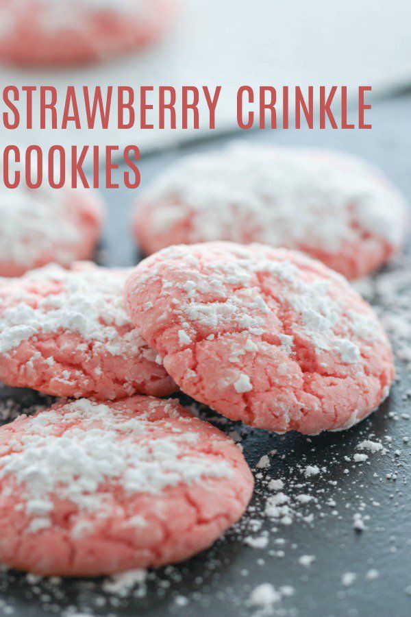 strawberry crinkle cookies with powdered sugar on top