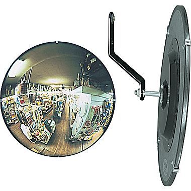 a mirror with an image of people in the reflection and on the wall next to it