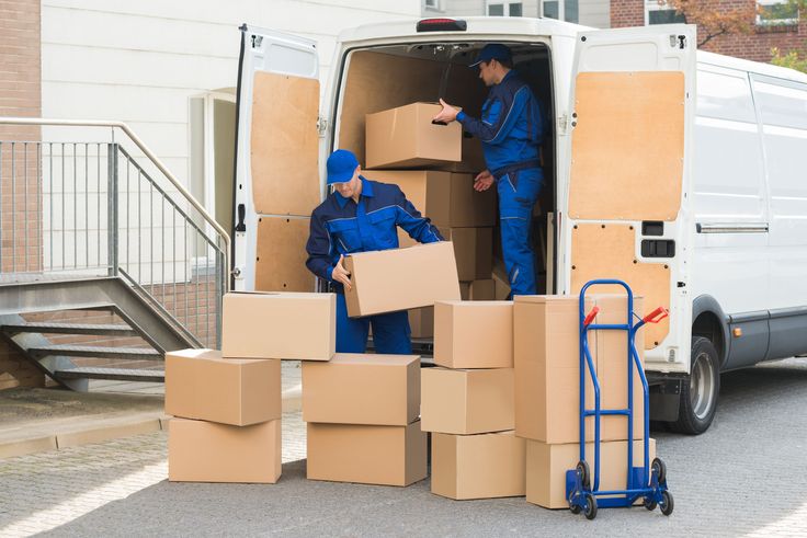 two men unloading boxes from the back of a van