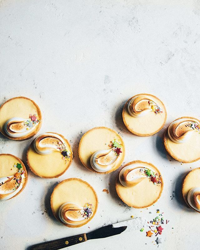 there are many small desserts on the table next to a pair of scissors and a knife