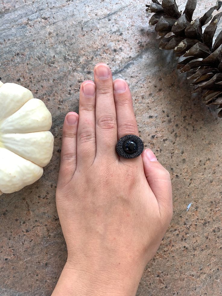 "14k Yellow Gold Sterling Silver Black Onyx Orb Pave Black Spinel Nest Ring Size 6.5 up for offer is a stunning 14k yellow gold over solid sterling silver black onyx orb set in a nest of pave black spinel ring. This ring is marked \"925\". Measurements Ring Size: 6.5 Band Width: 4mm Black Onyx Orb: 13mm Black Spinel: 1.3mm Weight: 9.5 g Materials -14k Yellow Gold -Sterling Silver -Black Onyx -Black Spinel Condition: New; Please look closely at the pictures provided as they are an extension of th Black Spinel Jewelry For Anniversary, Black Sapphire Gemstone Ring For Anniversary, Black Oval Cluster Ring For Anniversary, Black Round Sapphire Ring For Anniversary, Black Spinel Sapphire Ring Gift, Black Gemstone Ring For Anniversary, Anniversary Black Sapphire Ring, Black Gemstone Rings For Jewelry Making, Black Oval Ring With Black Diamonds