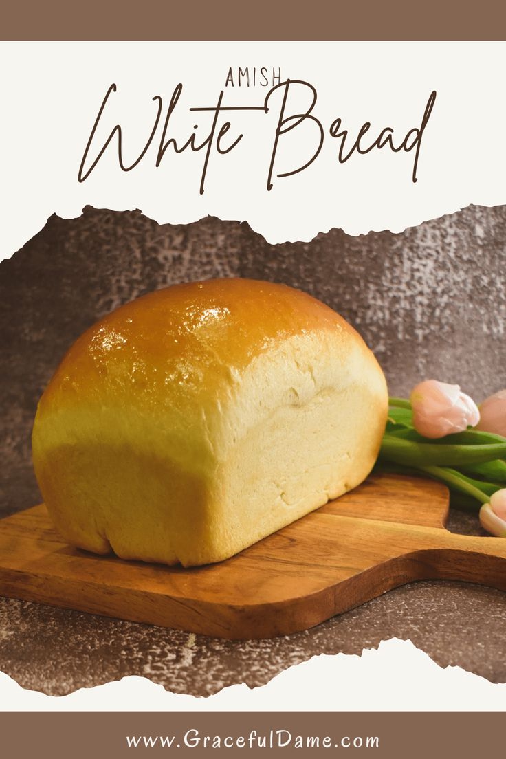 a loaf of bread sitting on top of a wooden cutting board