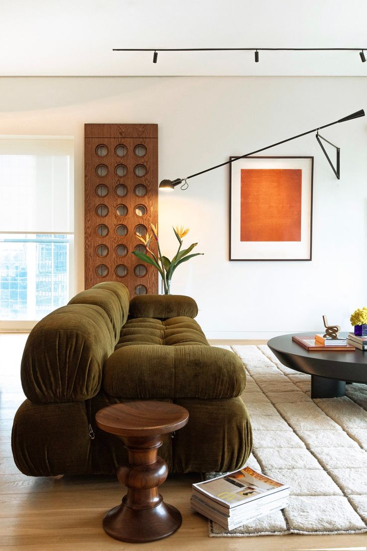 a living room filled with furniture and a painting on the wall