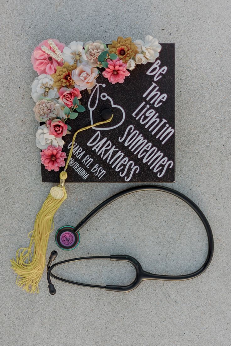 a graduation cap with flowers and a stethoscope