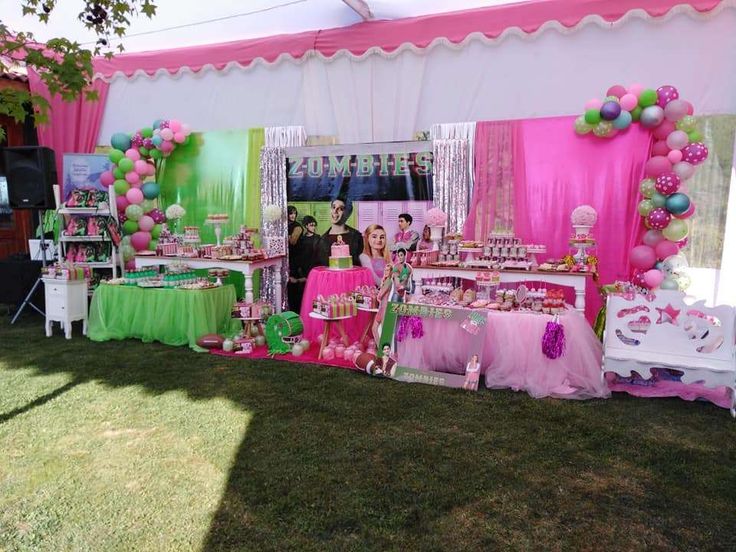 a pink and green birthday party with balloons, streamers, tablecloths and decorations