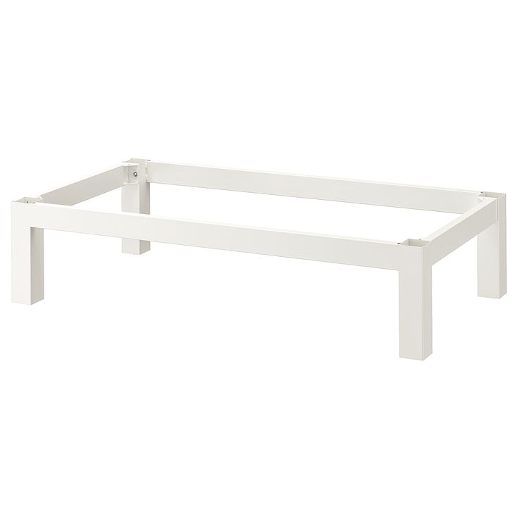 a white bed frame sitting on top of a white floor