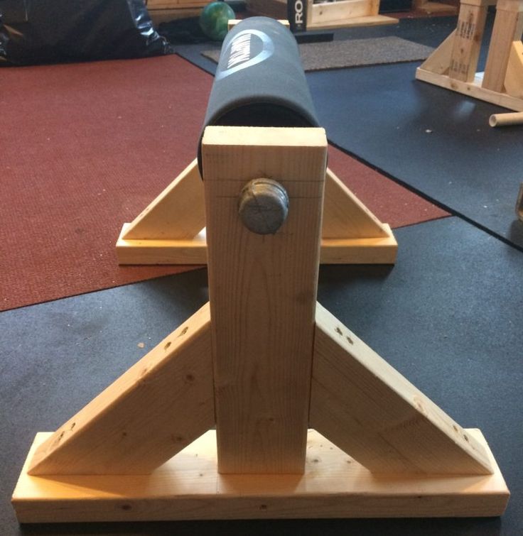 a wooden toy rocket sitting on top of a black table in a room with red carpet